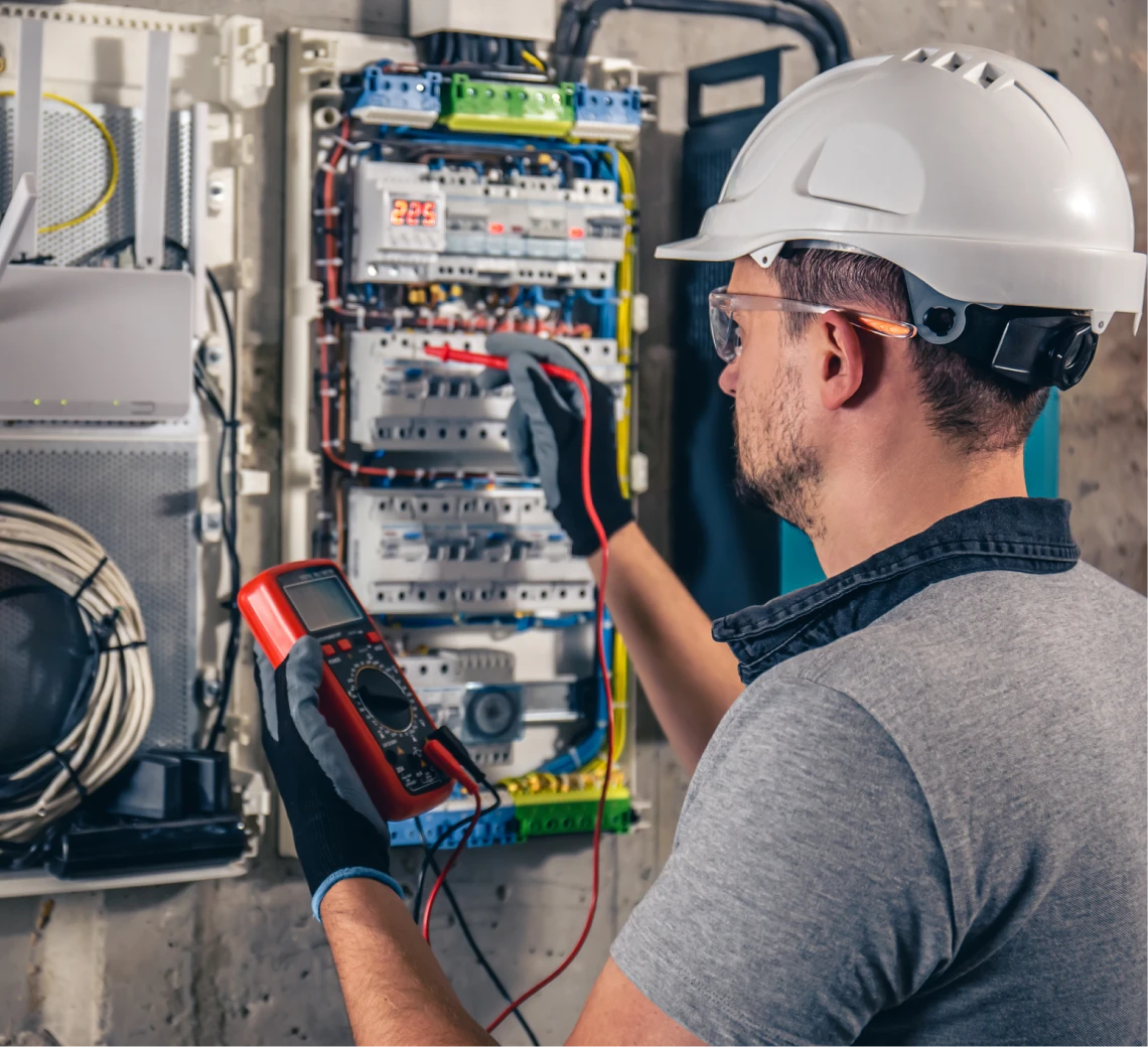 Electrician testing a circuit breaker panel.